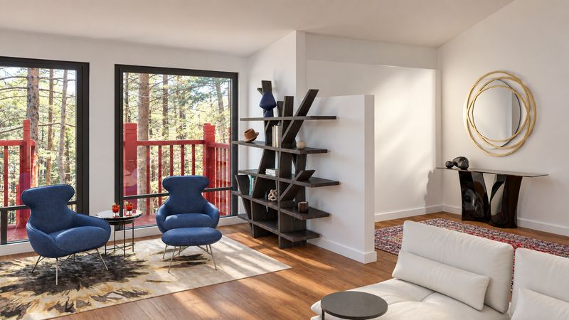 Blue lounge chairs, an open bookcase, and a round gold mirror, design visualization