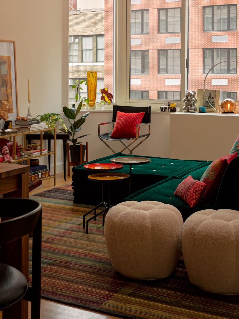 Living room with green velvet seating and bouclé poufs, Midtown Apartment