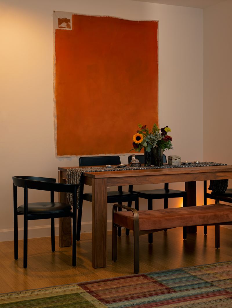 Dining room beneath an orange painting