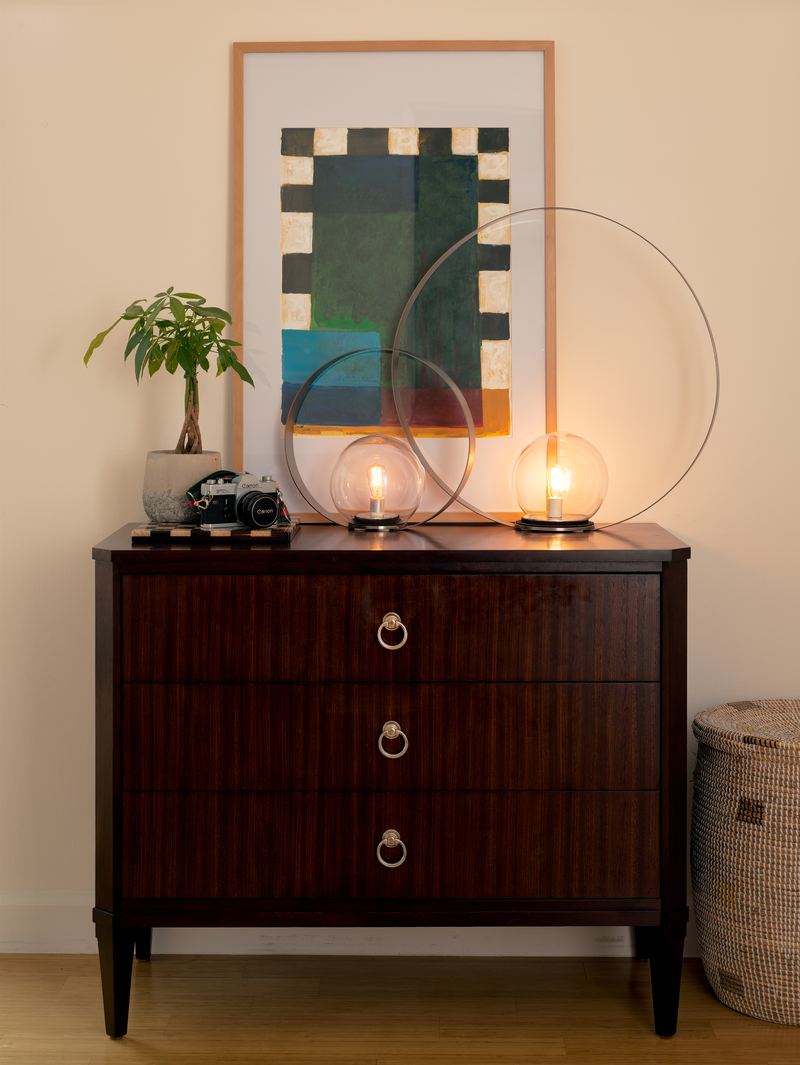 Dresser with glass lamps and artwork