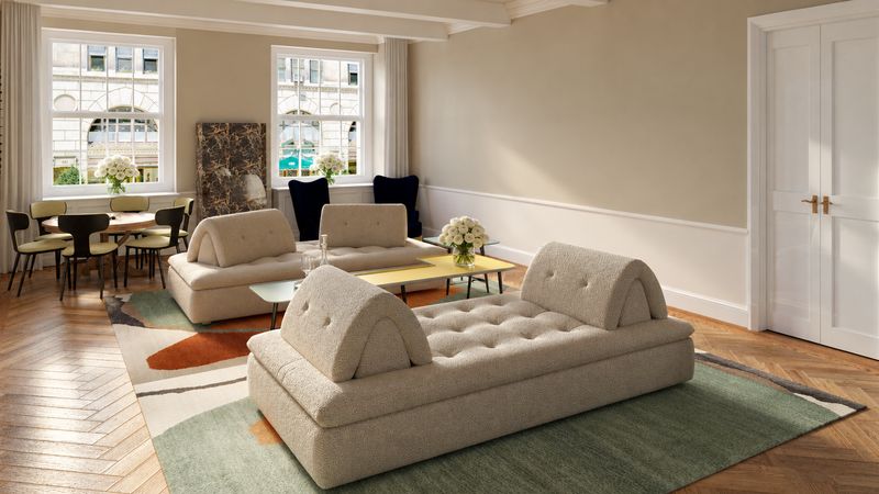 Two cream sofas on a green rug, with the dining table by the windows, design visualization