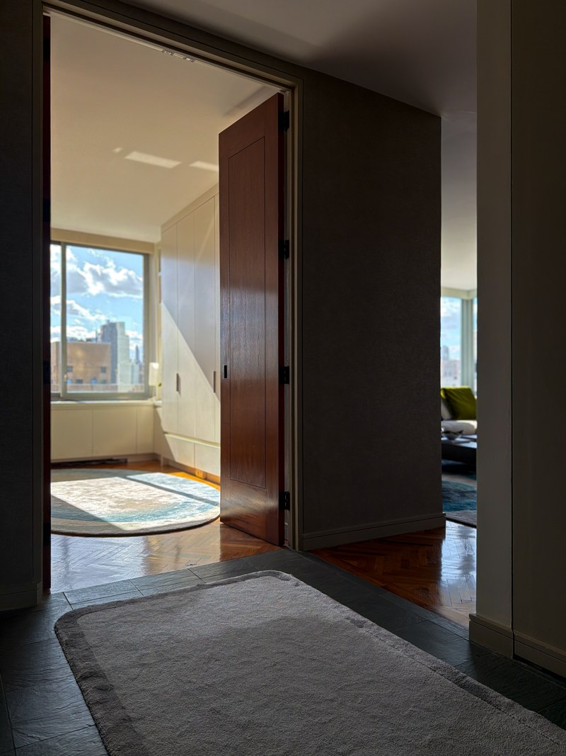 A sunlit room beyond the hallway