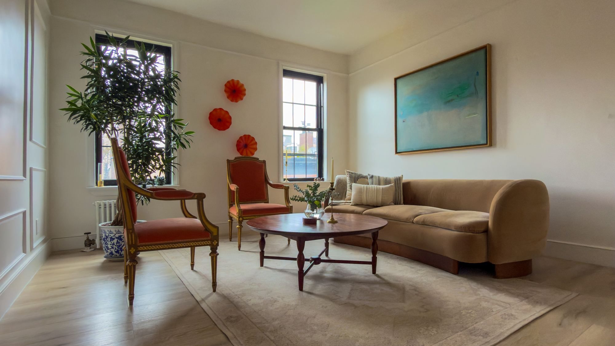 Collected furniture and art in a living room designed by Mazen Designs